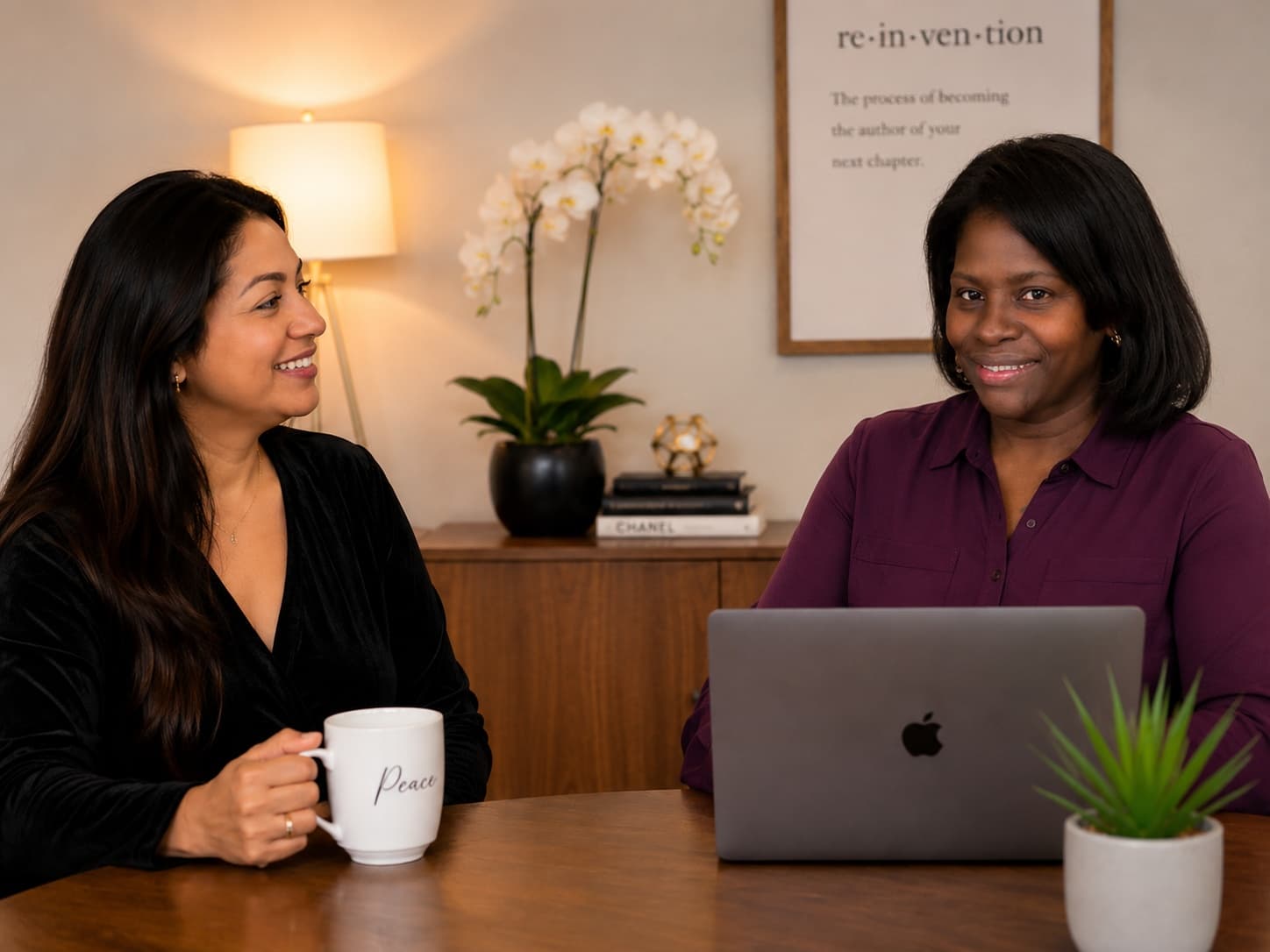 Giselle and a client smiling together over coffee during a one-on-one coaching session
